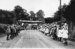 Wedding 1907, children lining New Road with banner over Long Life and Happiness